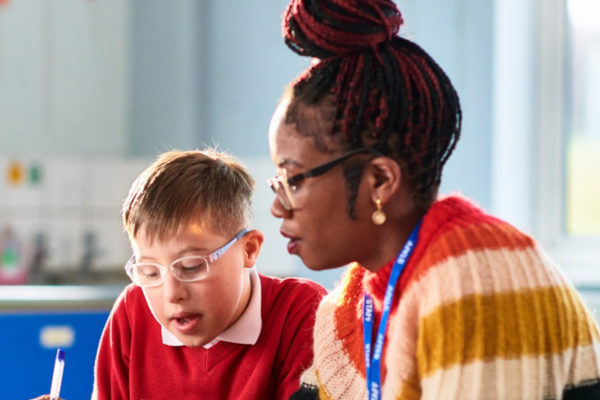 A teacher talking to a young student